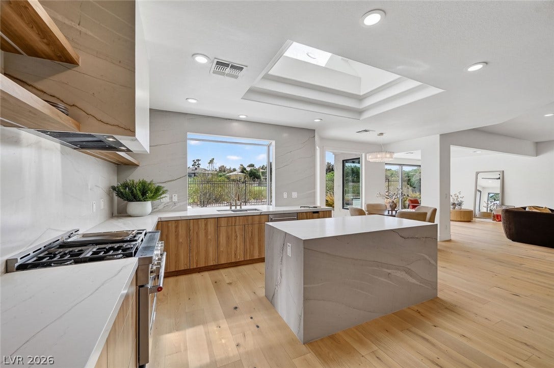 1900 Glenview Drive, Las Vegas, NV 89134 A spacious kitchen integrates custom cabinetry, stone counters, and a central skylight.
