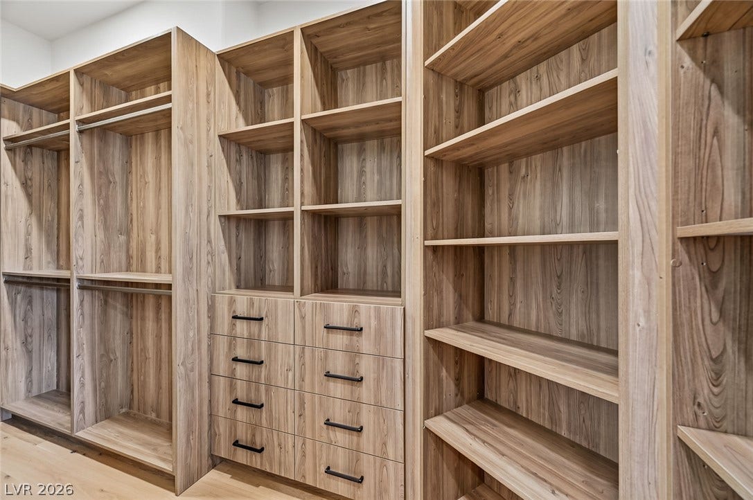 1900 Glenview Drive, Las Vegas, NV 89134 Custom wood shelving and integrated drawers maximize storage in this spacious walk-in closet.