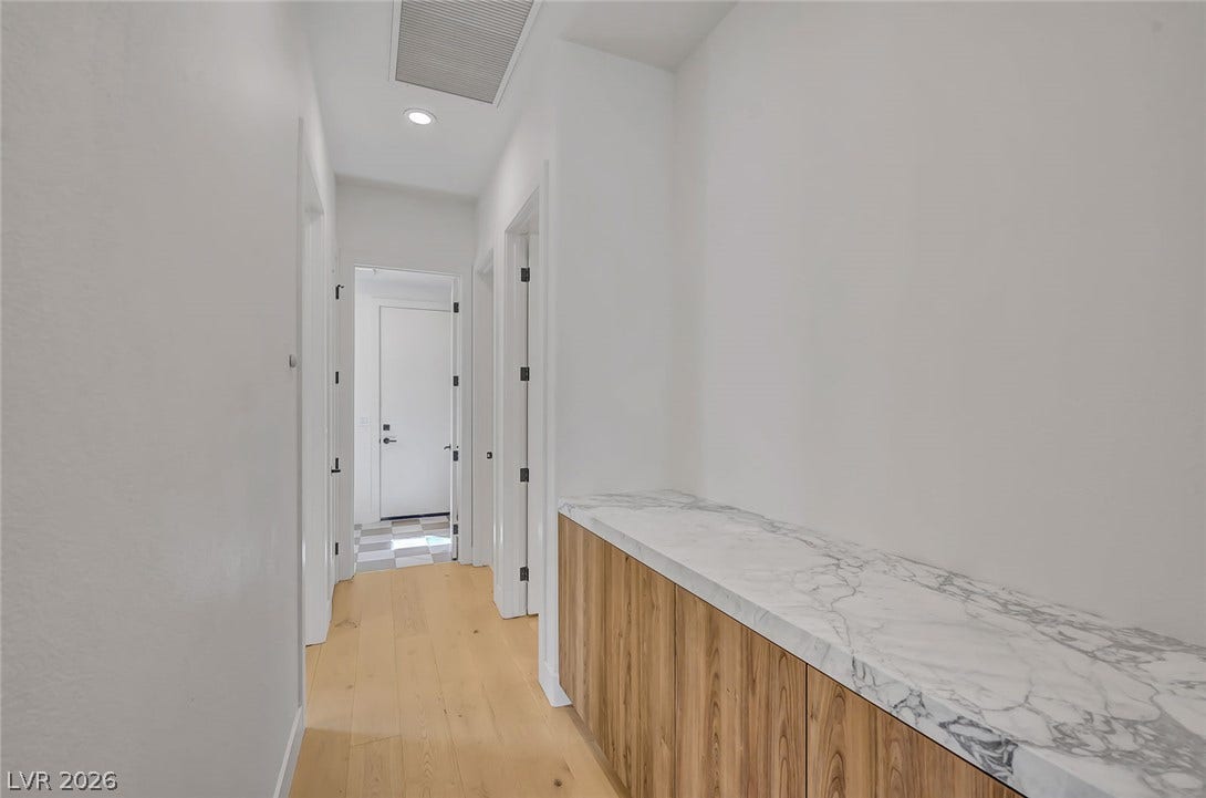 1900 Glenview Drive, Las Vegas, NV 89134 Smooth wood floors and recessed lighting guide movement through this clean-lined hallway.