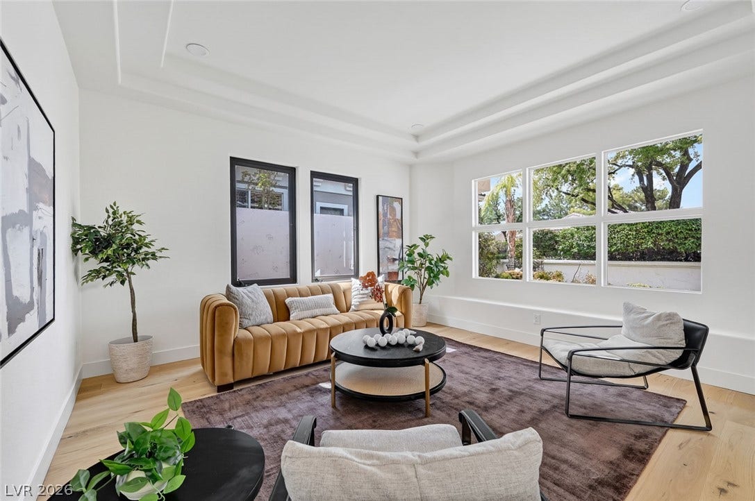 1900 Glenview Drive, Las Vegas, NV 89134 Multi-layered tray ceilings and expansive windows elevate this welcoming modern living space.
