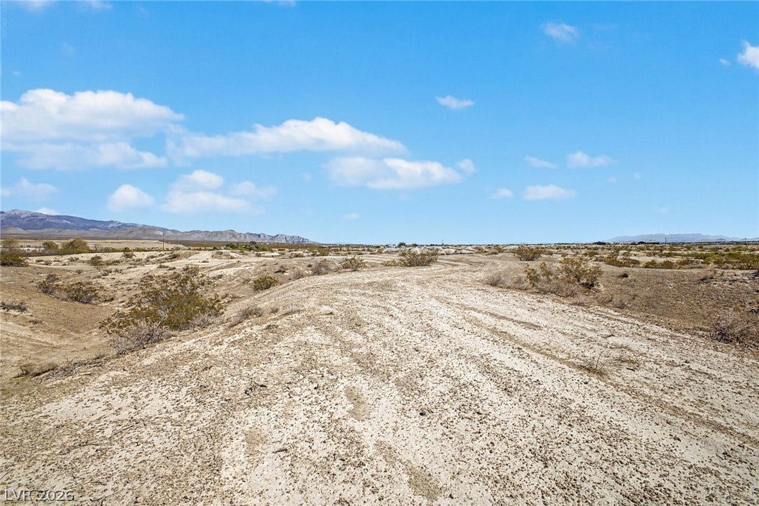 1621 Rockafeller Drive, Pahrump, NV 89060 A sweeping desert view showcases rugged terrain under a vast blue sky.