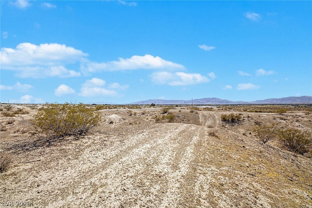 1621 Rockafeller Drive, Pahrump, NV 89060 Vast desert terrain stretches toward distant mountains under a wide blue sky.