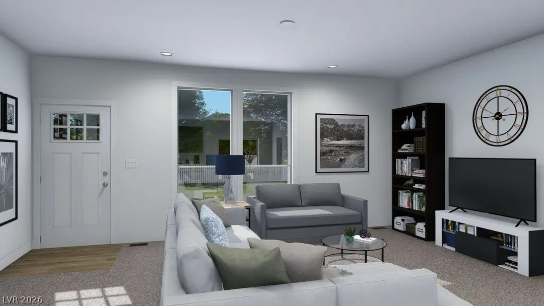 466 Box Canyon Road, Alamo, NV 89001 Sunlight streams through large windows into this welcoming living space with soft carpet flooring.