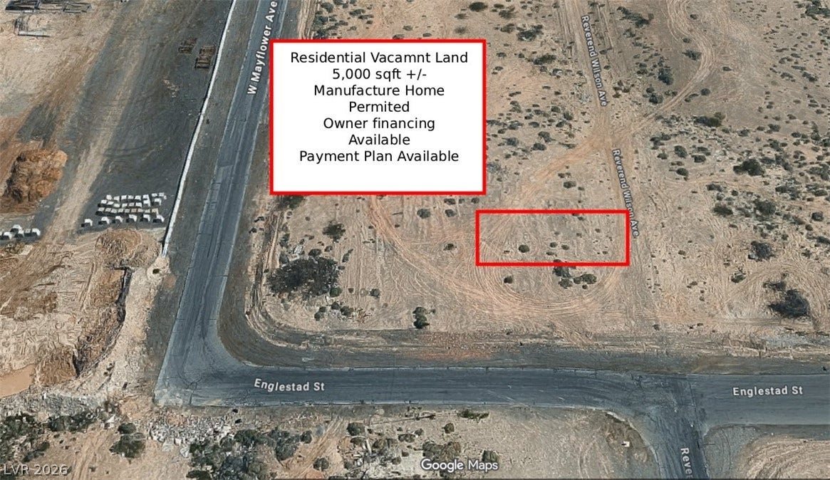 Aerial perspective reveals the vacant parcel outlined near street corners in a developing neighborhood.