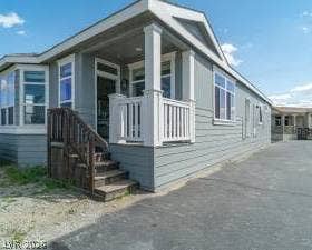 Crisp trim highlights the exterior of this modern manufactured home with a covered front porch.
