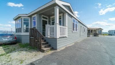 472 Box Canyon Road, Alamo, NV 89001 A classic front porch welcomes visitors to this charming modular home featuring a bay window.