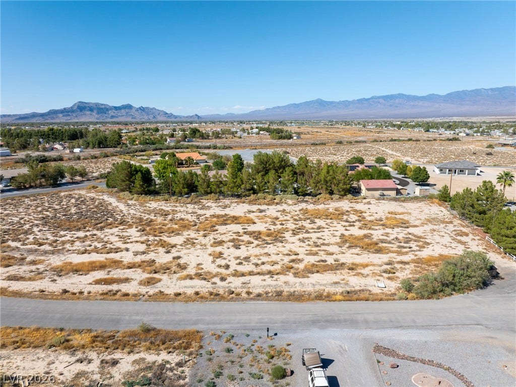 Vast desert parcels sit ready for development against a majestic mountain backdrop.