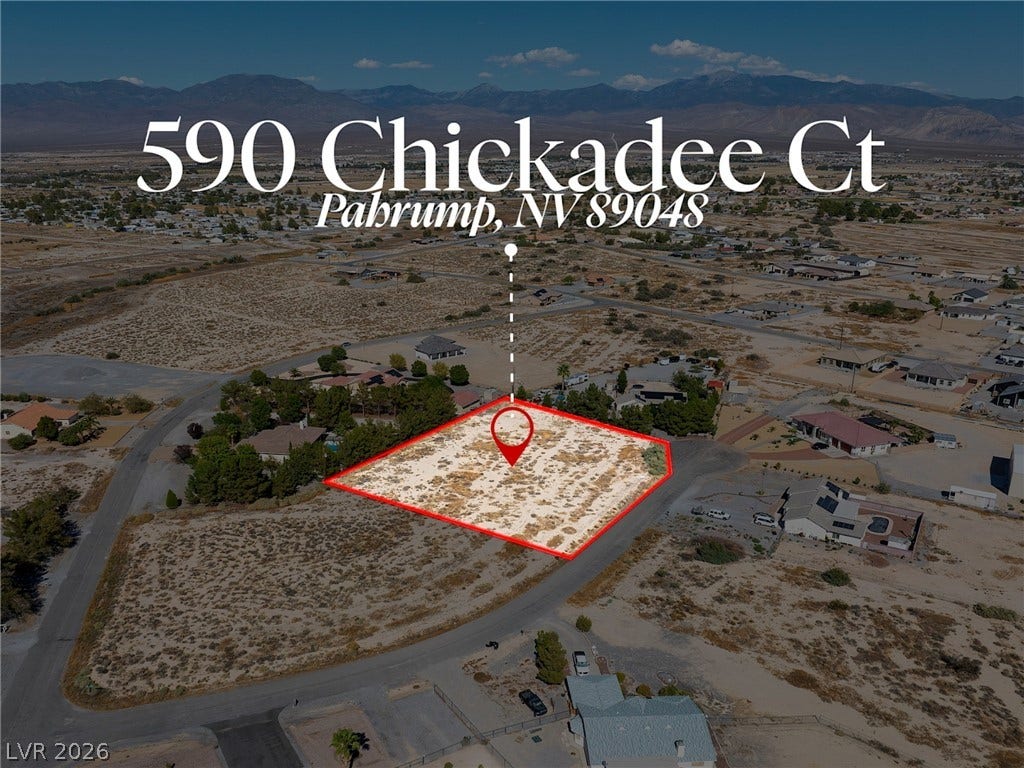 Vast desert horizons frame this prime development lot outlined against mountain backdrops.