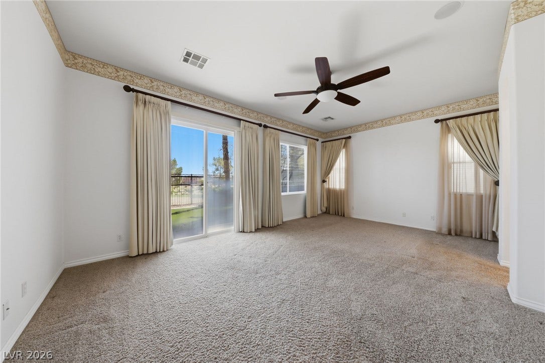 Glass sliding doors open directly to the backyard from this spacious carpeted room.
