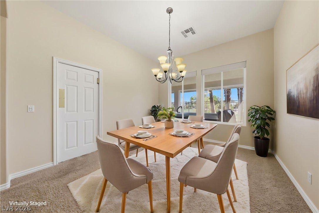 High ceilings and tall windows enhance the natural light in this refined dining area.
