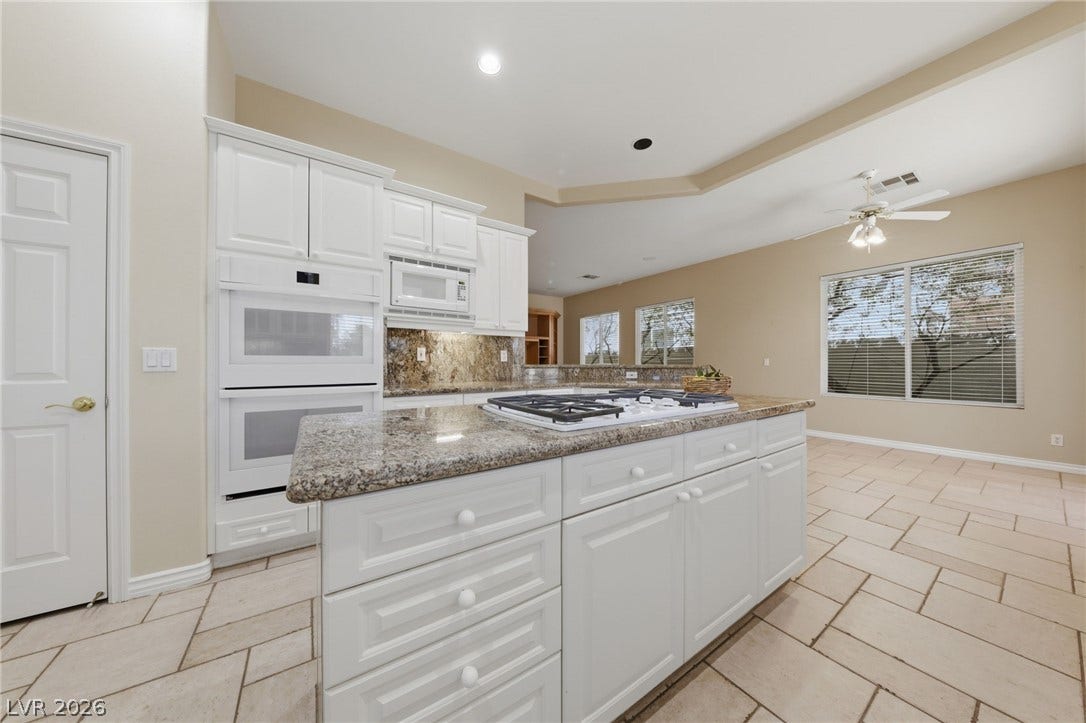 An open floor plan connects the kitchen island to the adjacent dining area.