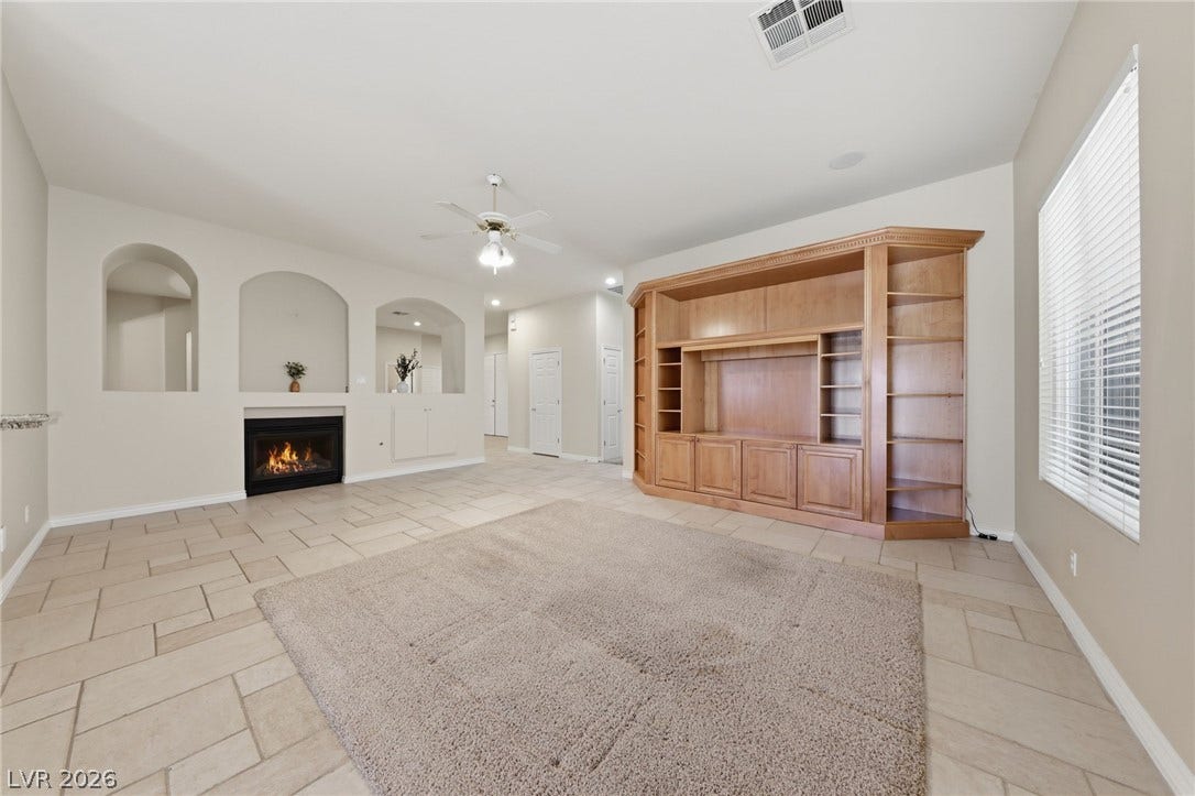 An integrated wood media center and tile flooring define this comfortable living space.