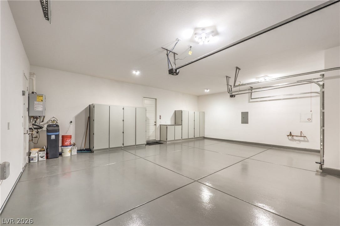 5455 Grambley Street, Las Vegas, NV 89149 Oversized 3 car garage with cabinets, epoxy floor, storage cabinets & car charger
