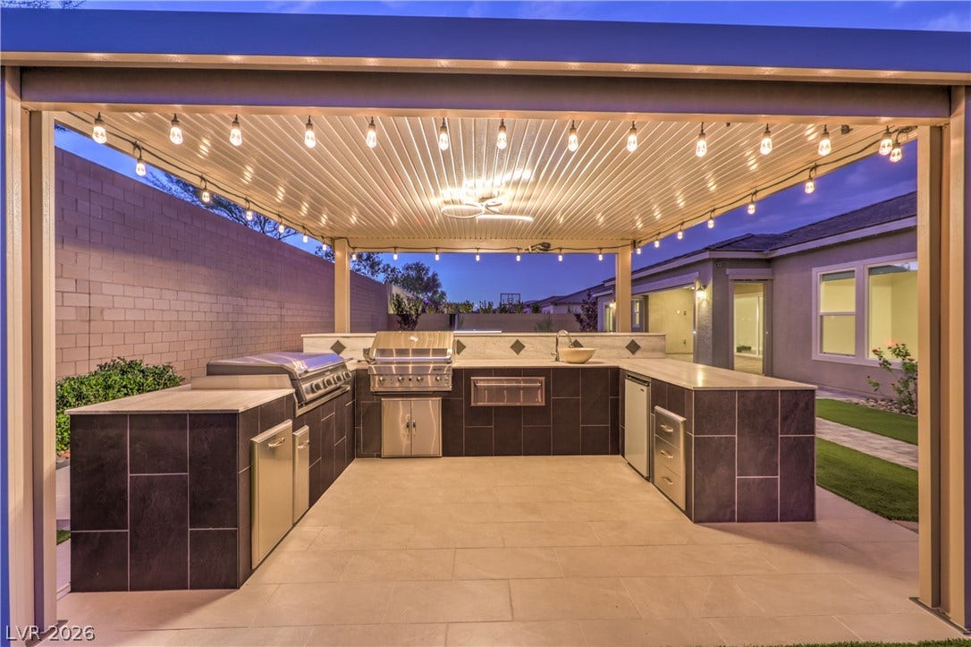 5455 Grambley Street, Las Vegas, NV 89149 Cover Outdoor kitchen with Blackstone griddle, gas BBQ, warming drawer and refrigerator. Plenty of counter space with custom lighting