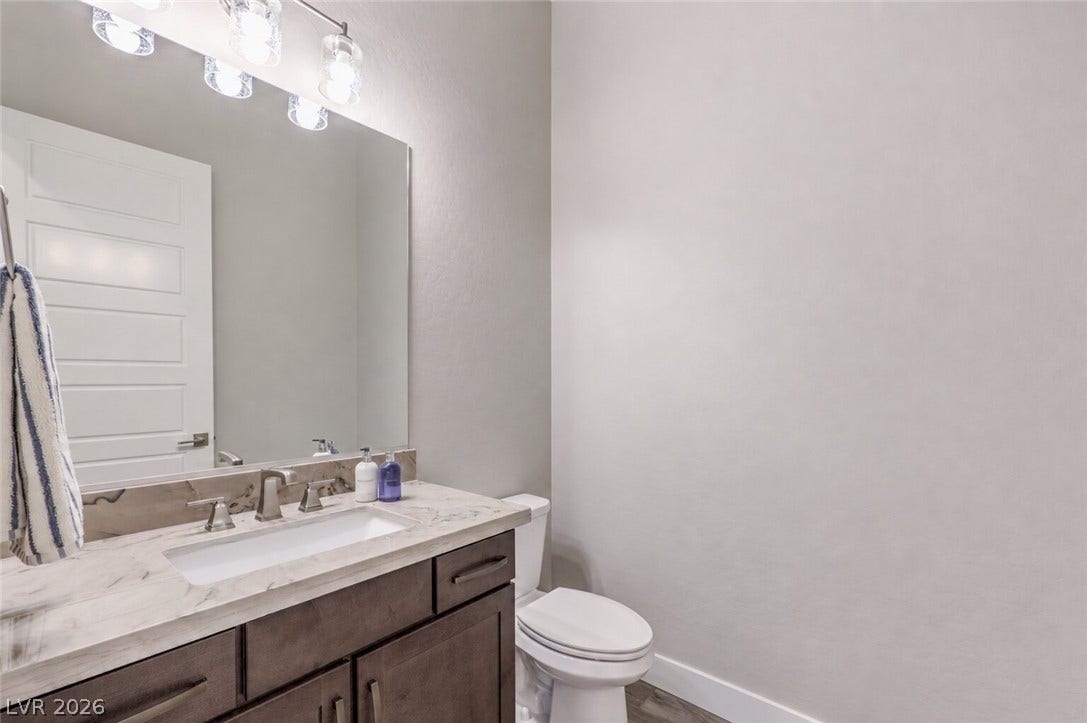 5455 Grambley Street, Las Vegas, NV 89149 Powder room off of the office with high-quality quartzite counter and 10-foot ceilings