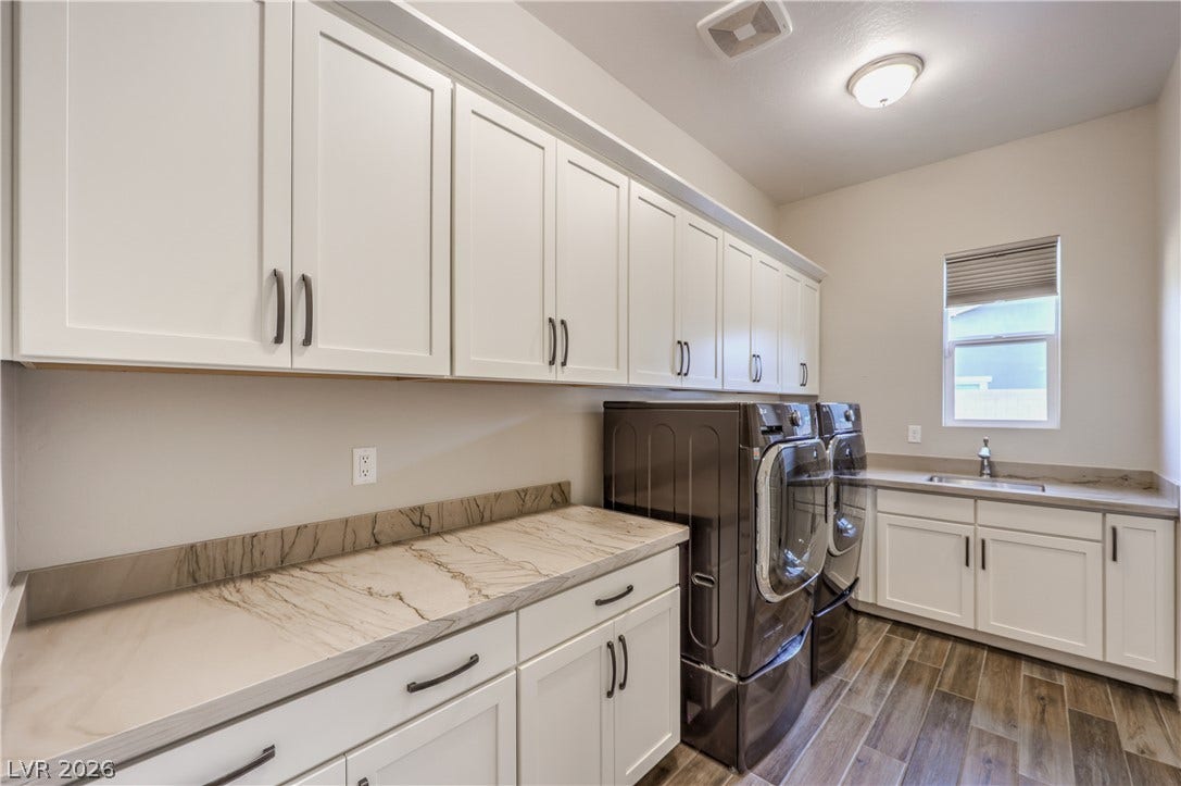 5455 Grambley Street, Las Vegas, NV 89149 Laundry with loads of cabinets, same high-quality quartzite counters and large sink. Pedestal washer machine with 2nd small load washer and dryer. Laundry room leads to primary bedroom closet for conveyance