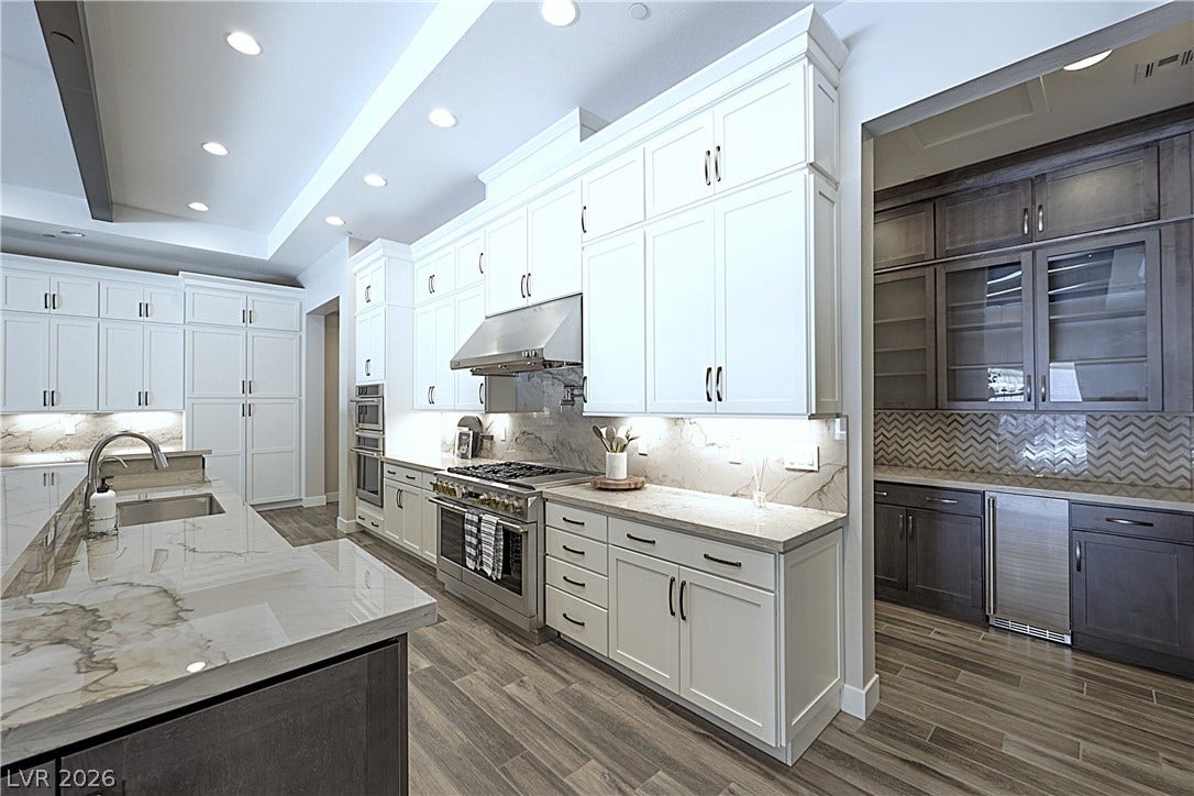5455 Grambley Street, Las Vegas, NV 89149 48in gas 6 burner range plus grill, 2 ovens, warming lights, pot filler, full quartzite back splash, double stacked cabinets, 3rd over and microwave, under cabinet lighting, butler pantry, bar area with glass door cabinet fronts and ice maker