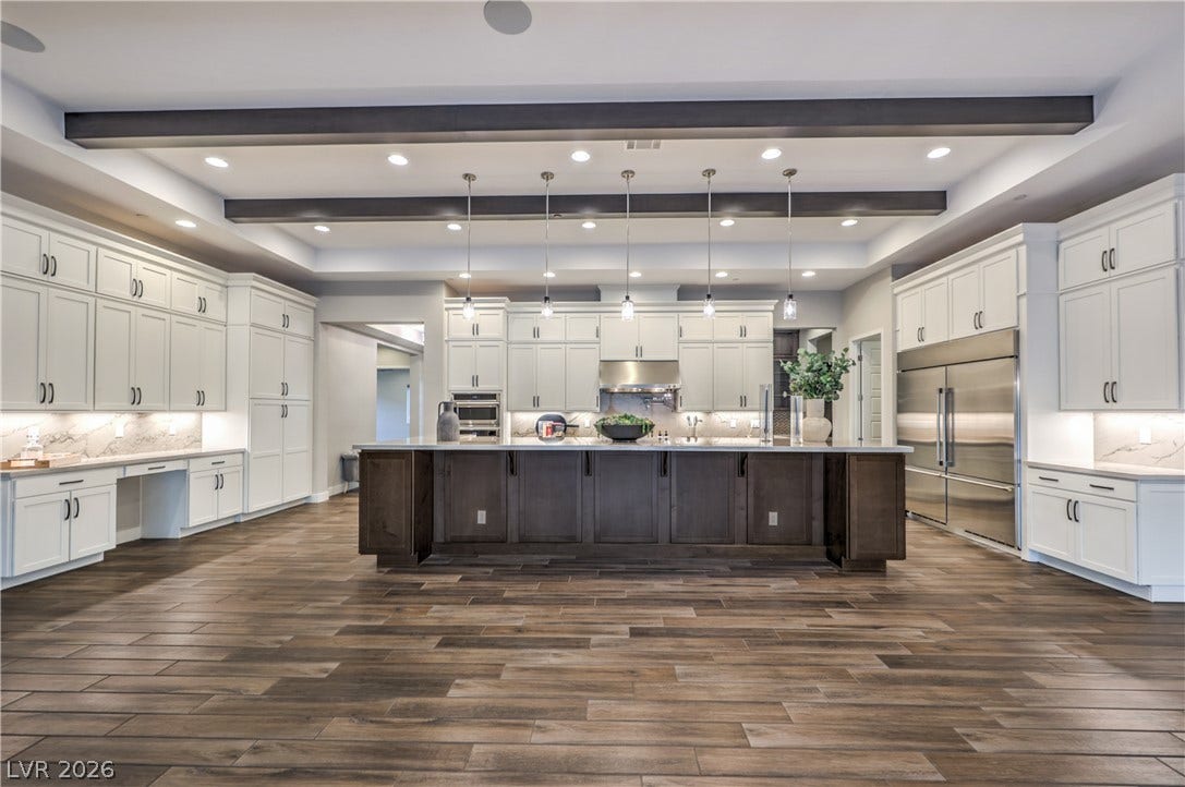5455 Grambley Street, Las Vegas, NV 89149 Gorgeous kitchen with 72 in stainless refrigerator, pedant lights and enormous amount of storage walk-in pantry, porcelain floors throughout living areas