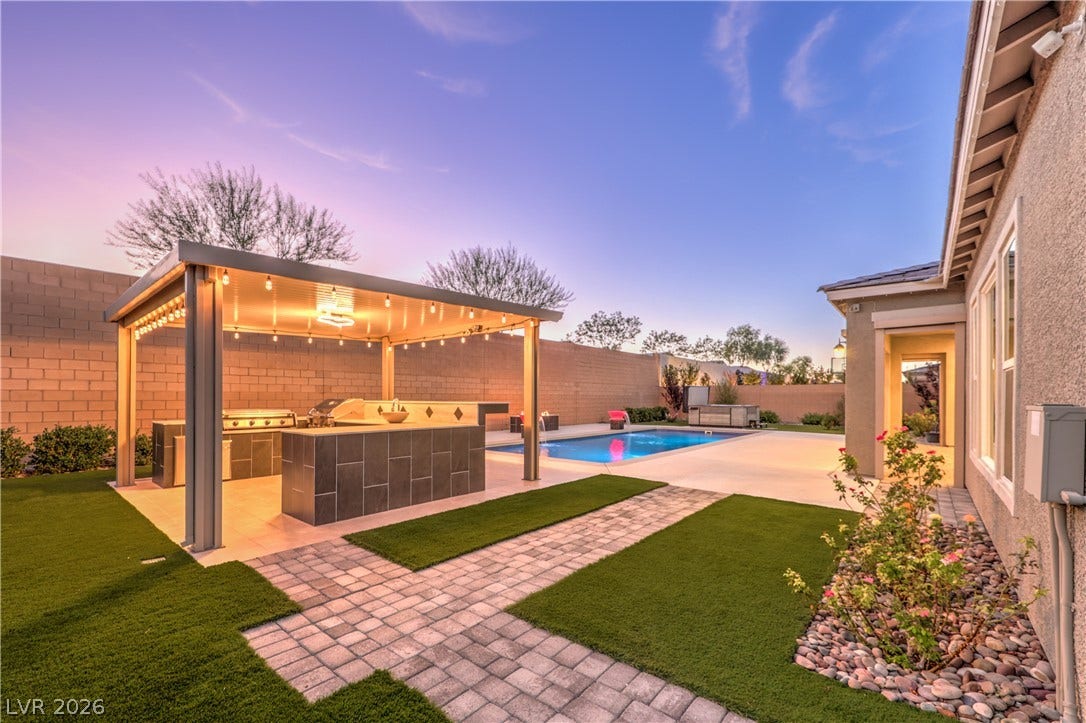 5455 Grambley Street, Las Vegas, NV 89149 Covered and custom lighting Outdoor kitchen with Blackstone griddle, and Gas BBQ, warming drawer, refrigerator and storage drawer! Perfect for family and/or friend gatherings!