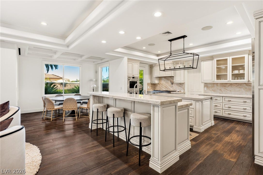 9817 Mountain Grove Court, Las Vegas, NV 89134 Rich hardwood floors contrast with clean white cabinetry and classic coffered ceilings.