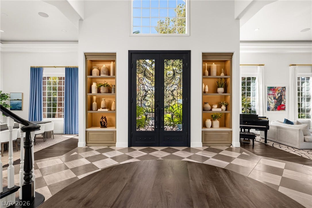 9817 Mountain Grove Court, Las Vegas, NV 89134 A grand entry showcases soaring ceilings, custom built-in shelving, and striking double front doors.