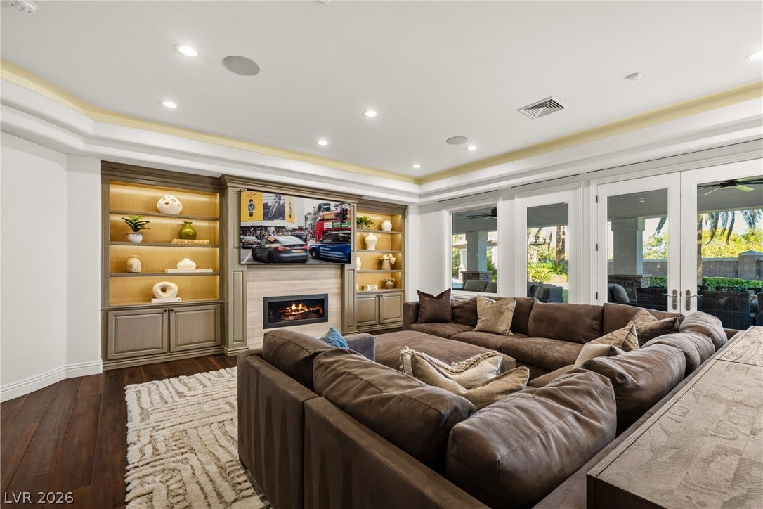 9817 Mountain Grove Court, Las Vegas, NV 89134 Gleaming wood floors pair with a cozy fireplace and custom built-in shelving.