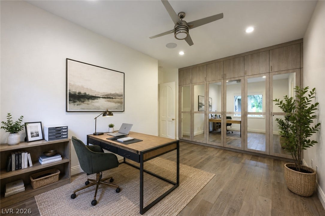9817 Mountain Grove Court, Las Vegas, NV 89134 Smooth wood floors and extensive custom cabinetry with mirrored fronts enhance this versatile workspace.