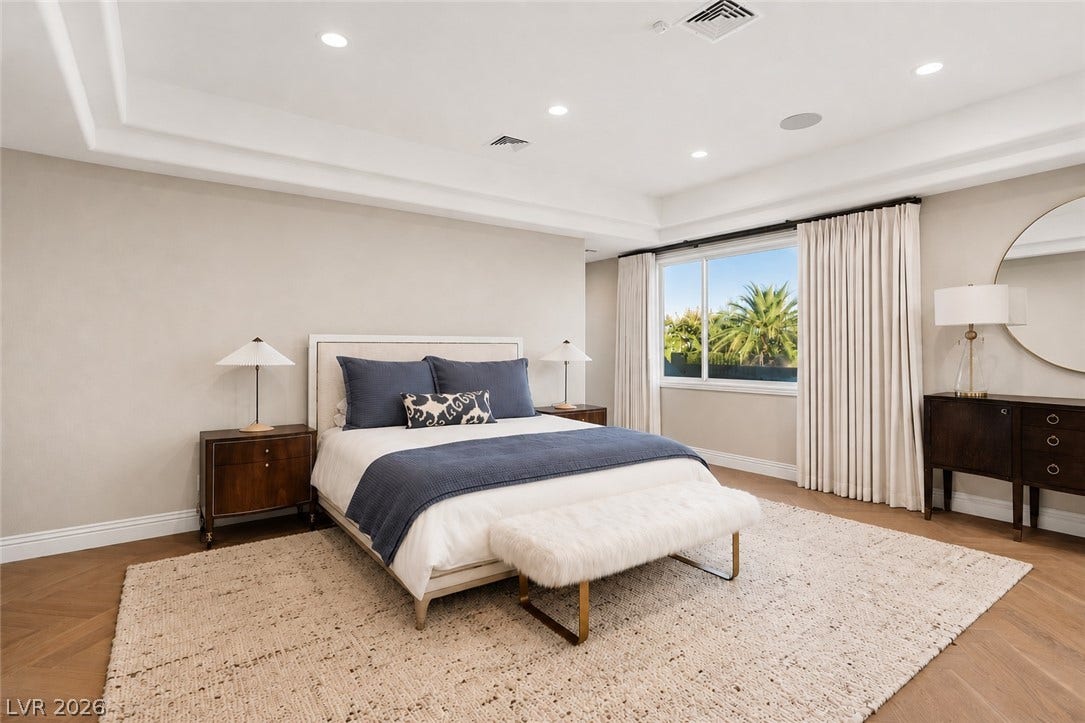 9817 Mountain Grove Court, Las Vegas, NV 89134 Gleaming chevron wood floors pair beautifully with a deep tray ceiling in this serene suite.
