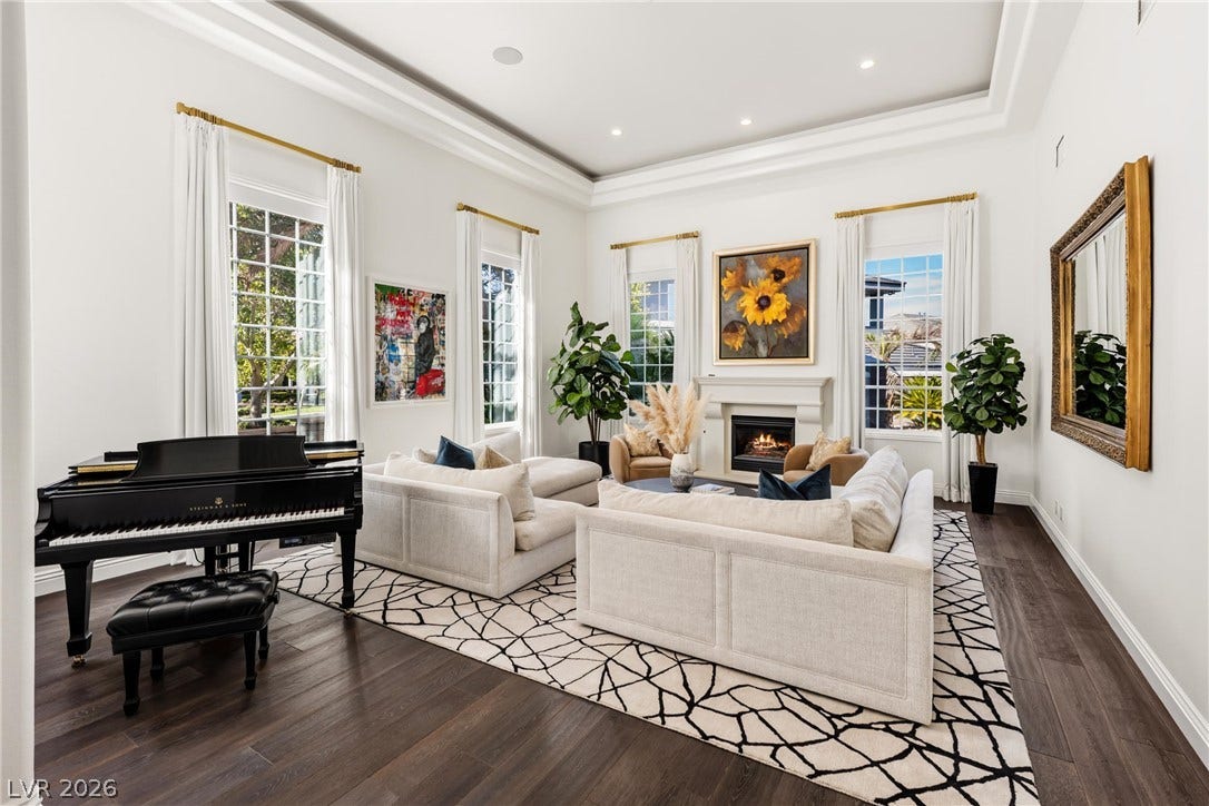 9817 Mountain Grove Court, Las Vegas, NV 89134 Soaring tray ceilings and dark wood floors define this grand formal living space.