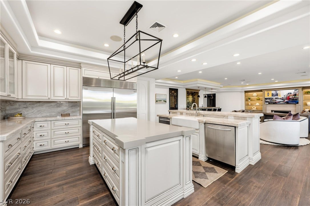 9817 Mountain Grove Court, Las Vegas, NV 89134 An open floorplan seamlessly connects the culinary space to the living area over rich wood flooring.