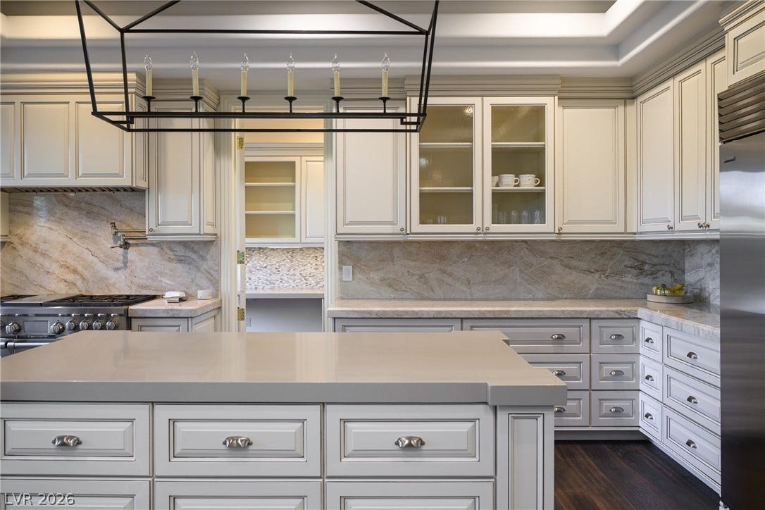 9817 Mountain Grove Court, Las Vegas, NV 89134 Premium stone countertops paired with custom cabinetry create an elegant culinary workspace.