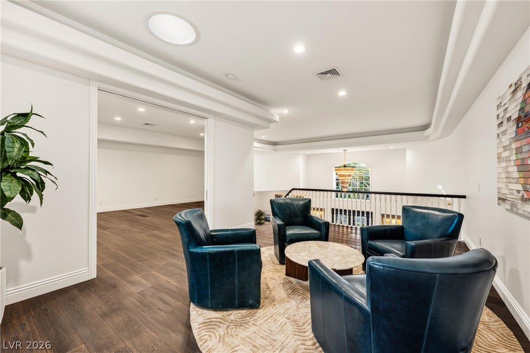 9817 Mountain Grove Court, Las Vegas, NV 89134 Rich hardwood flooring and custom crown molding define this versatile upper-level landing.
