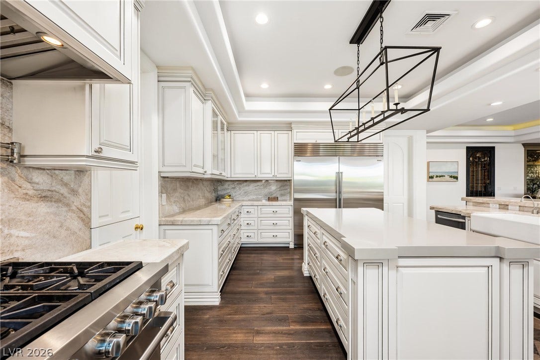 9817 Mountain Grove Court, Las Vegas, NV 89134 Gleaming stone countertops and rich hardwood floors define this masterfully designed culinary space.