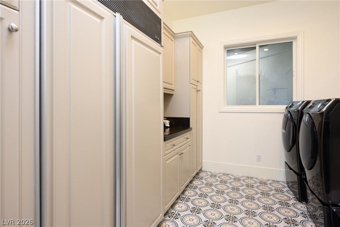 9817 Mountain Grove Court, Las Vegas, NV 89134 Patterned tile flooring and abundant cabinetry elevate this functional utility space.
