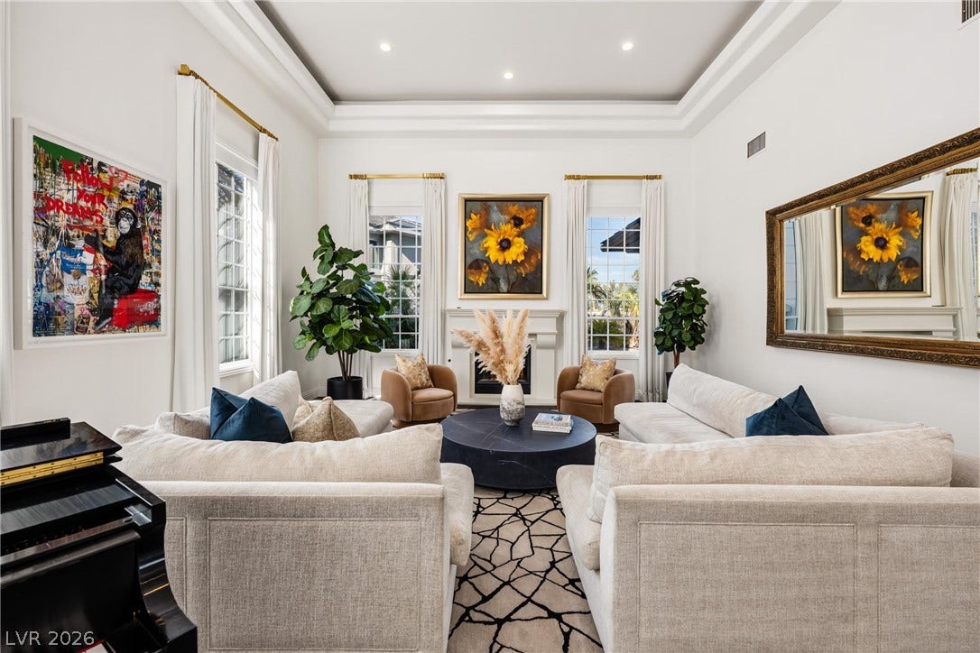 9817 Mountain Grove Court, Las Vegas, NV 89134 Crown molding accents the high tray ceiling of this welcoming, light-filled living area.