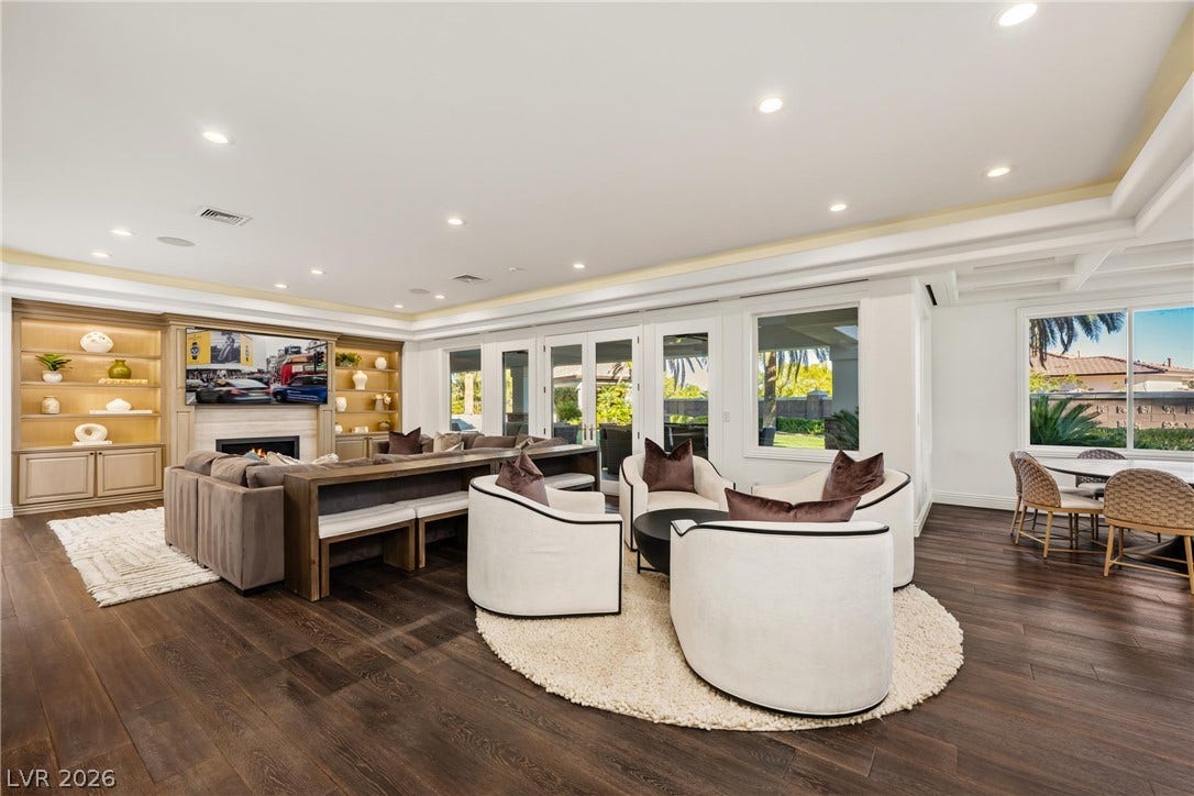 9817 Mountain Grove Court, Las Vegas, NV 89134 Rich hardwood flooring complements custom built-ins and recessed lighting in this seamless open space.