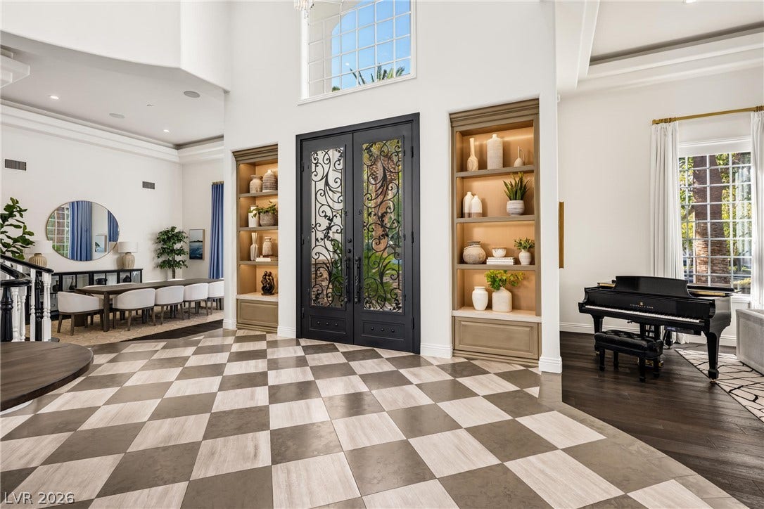 9817 Mountain Grove Court, Las Vegas, NV 89134 Ornate double doors frame a grand foyer featuring checkerboard floors and custom built-in shelving.