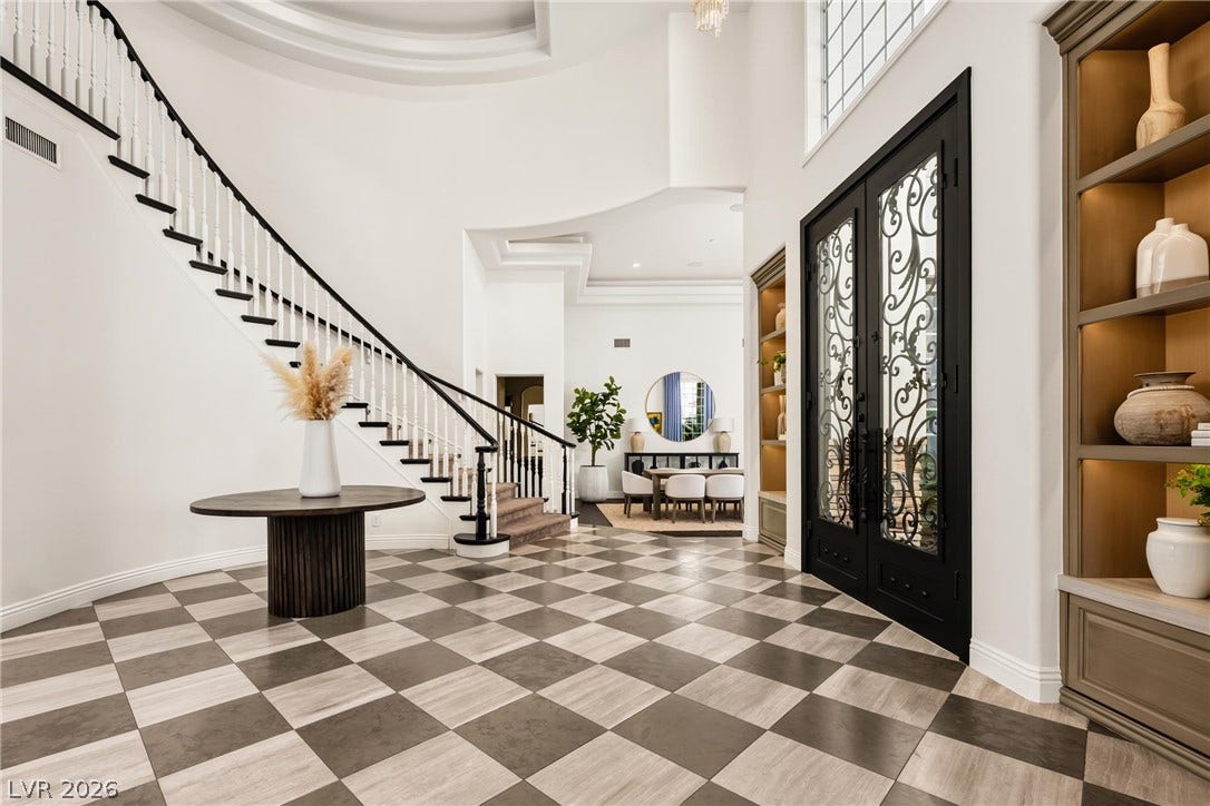 9817 Mountain Grove Court, Las Vegas, NV 89134 Ornate double entry doors open into a grand foyer featuring checkerboard flooring and a sweeping staircase.