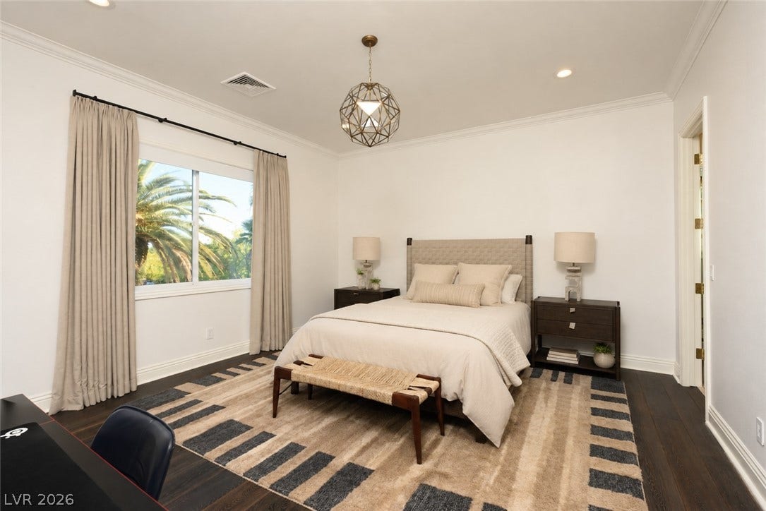 9817 Mountain Grove Court, Las Vegas, NV 89134 Polished hardwood floors and classic crown molding frame this restful, well-lit sleeping space.