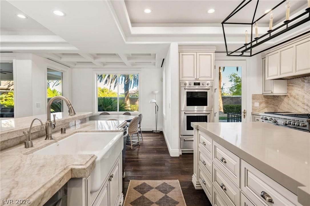 9817 Mountain Grove Court, Las Vegas, NV 89134 Rich hardwood floors contrast beautifully with light stone countertops and custom architectural ceilings.