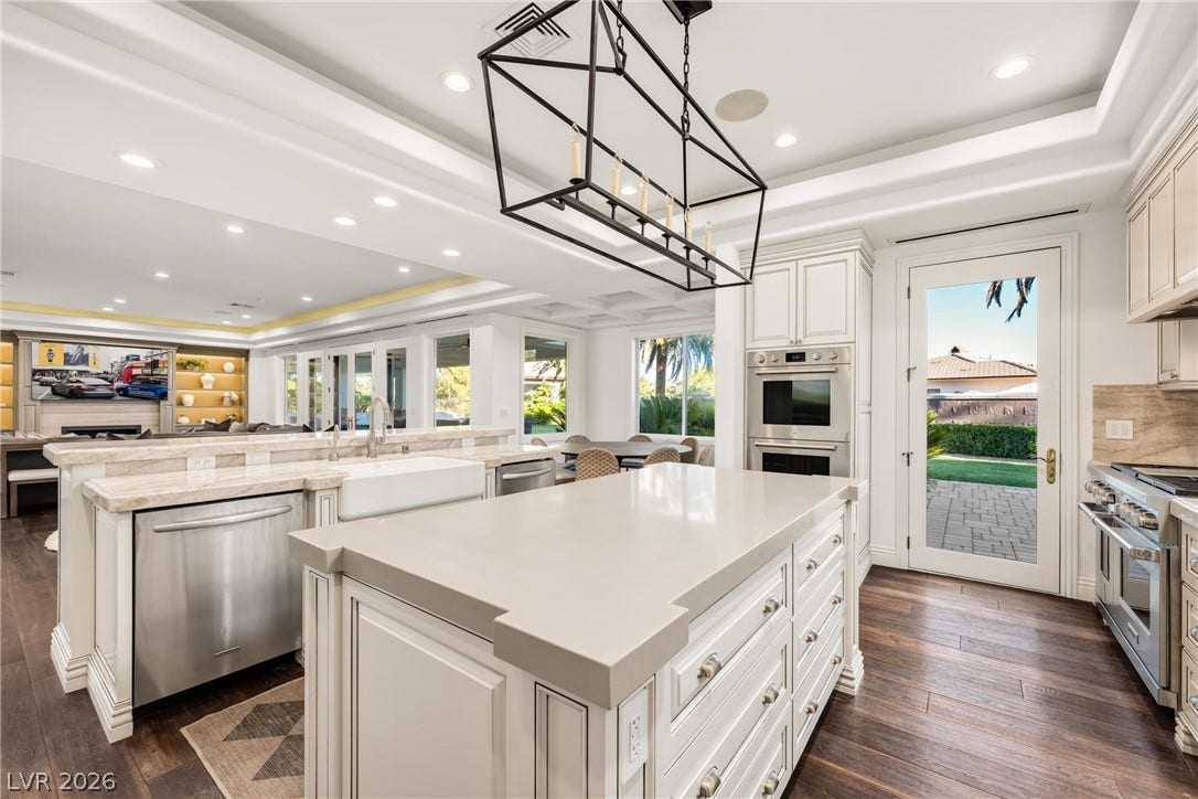 9817 Mountain Grove Court, Las Vegas, NV 89134 Gleaming hardwood floors and a spacious central island define this modern, sunlit kitchen space.