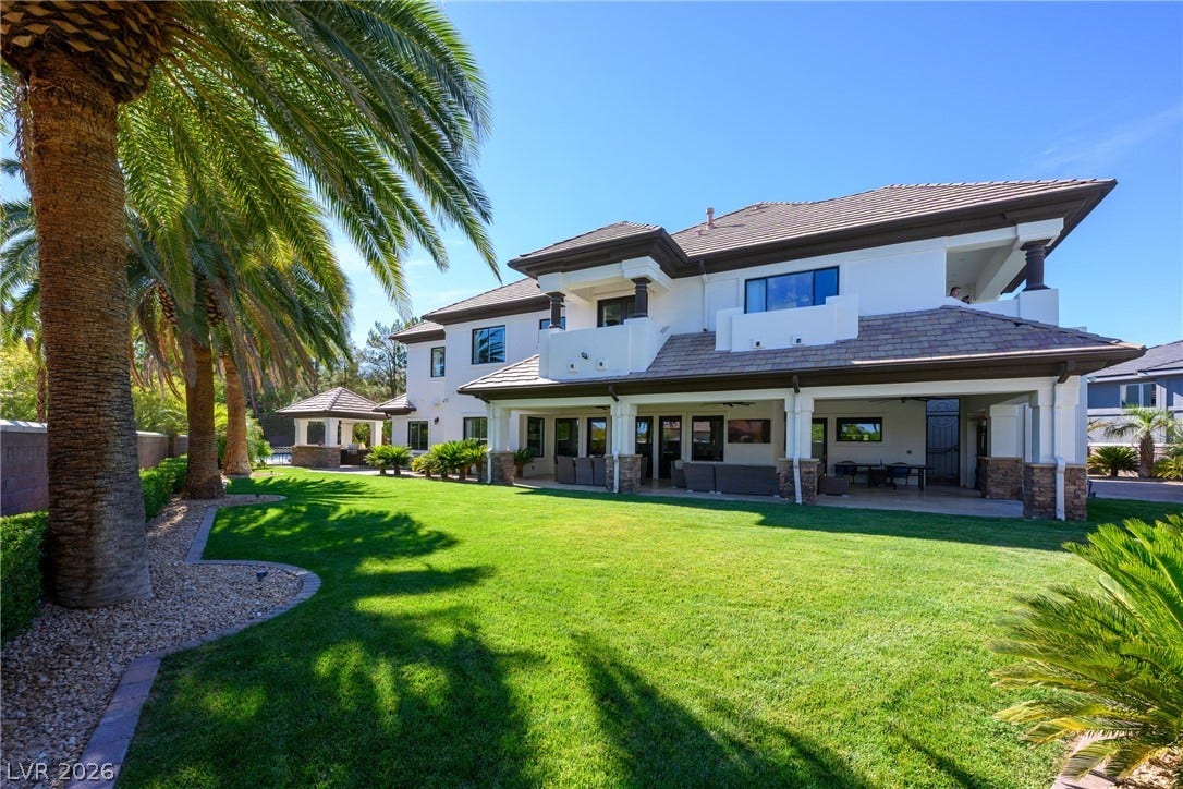 9817 Mountain Grove Court, Las Vegas, NV 89134 Manicured green lawns stretch alongside this multi-level home featuring deep covered patios and classic tiled roofing.