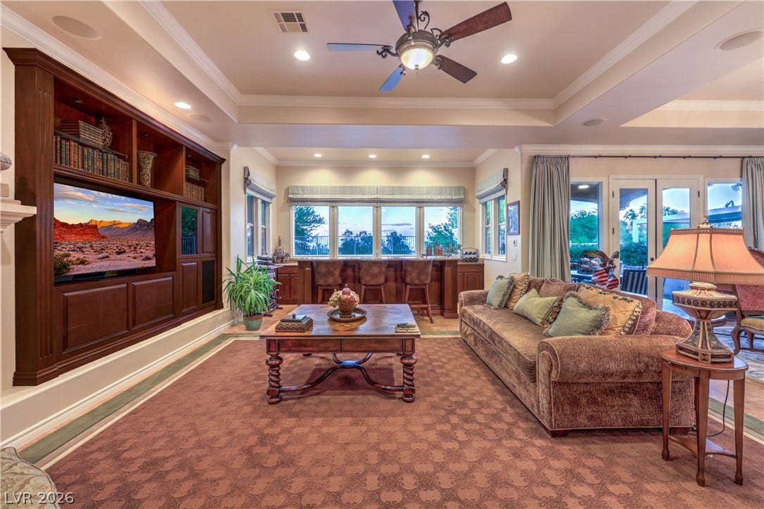 24 CROSS RIDGE Street, Las Vegas, NV 89135 Rich wood built-ins and elegant crown moldings define this comfortable living space.