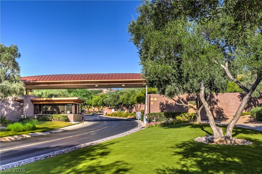 24 CROSS RIDGE Street, Las Vegas, NV 89135 Mature trees frame the secure gated entrance to this exclusive neighborhood.