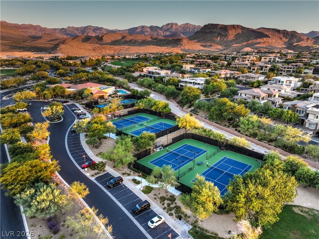 24 CROSS RIDGE Street, Las Vegas, NV 89135 Dramatic mountain peaks frame a neighborhood showcasing tennis and pickleball courts.