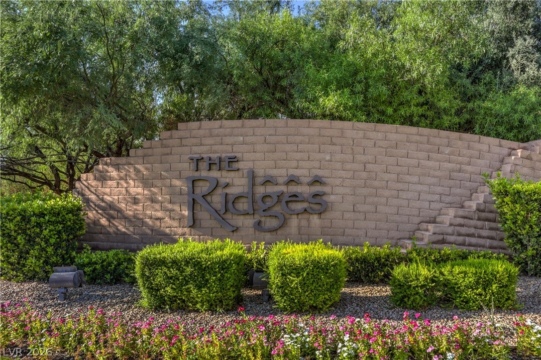 24 CROSS RIDGE Street, Las Vegas, NV 89135 Mature trees and neat brick masonry frame the welcoming neighborhood entryway monument.