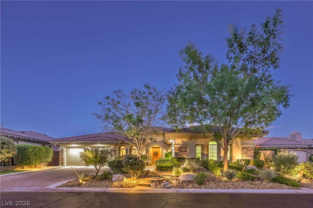 24 CROSS RIDGE Street, Las Vegas, NV 89135 Lush landscaping and desert stone accents frame this single-level residence under a tiled roof.