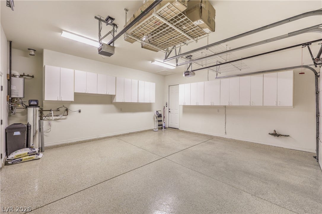 24 CROSS RIDGE Street, Las Vegas, NV 89135 Ample built-in cabinetry and finished floors elevate this highly functional garage space.