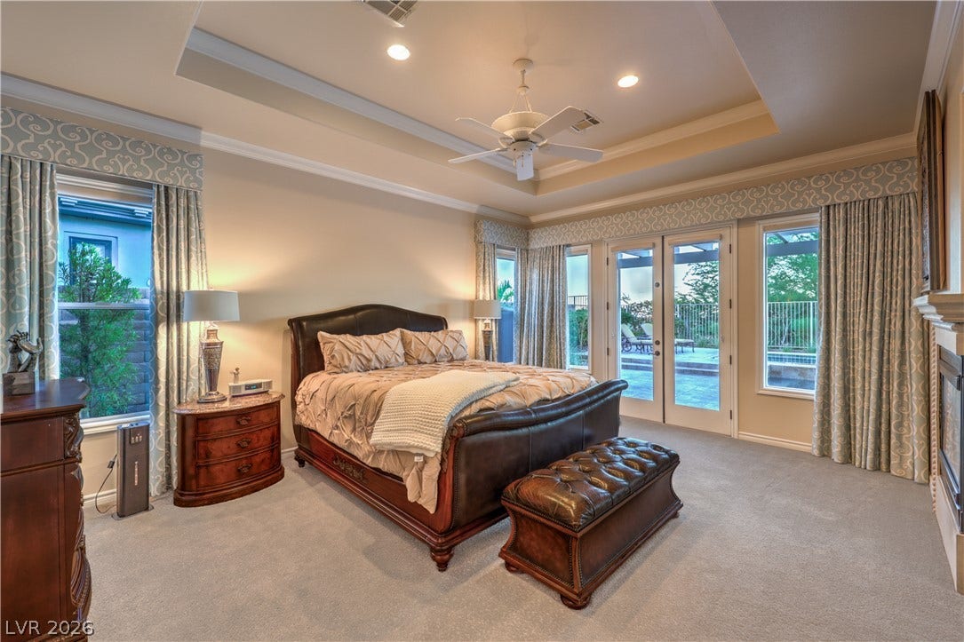 24 CROSS RIDGE Street, Las Vegas, NV 89135 A tray ceiling and French doors opening to the patio highlight this spacious bedroom.