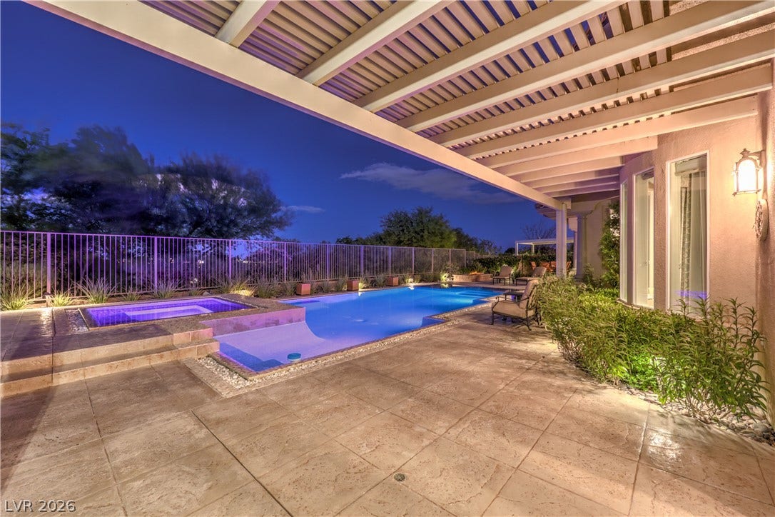 24 CROSS RIDGE Street, Las Vegas, NV 89135 An inviting covered patio overlooks a beautiful private pool and spa at dusk.